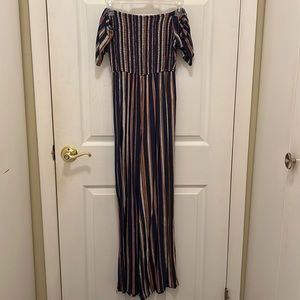Dark blue with pink, yellow and white stripe jumpsuit. Size XS
